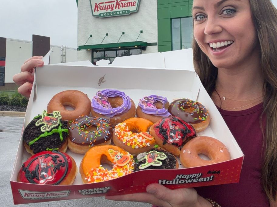 Woman holding a dozen Looney Tunes Krispy Kreme Doughnuts