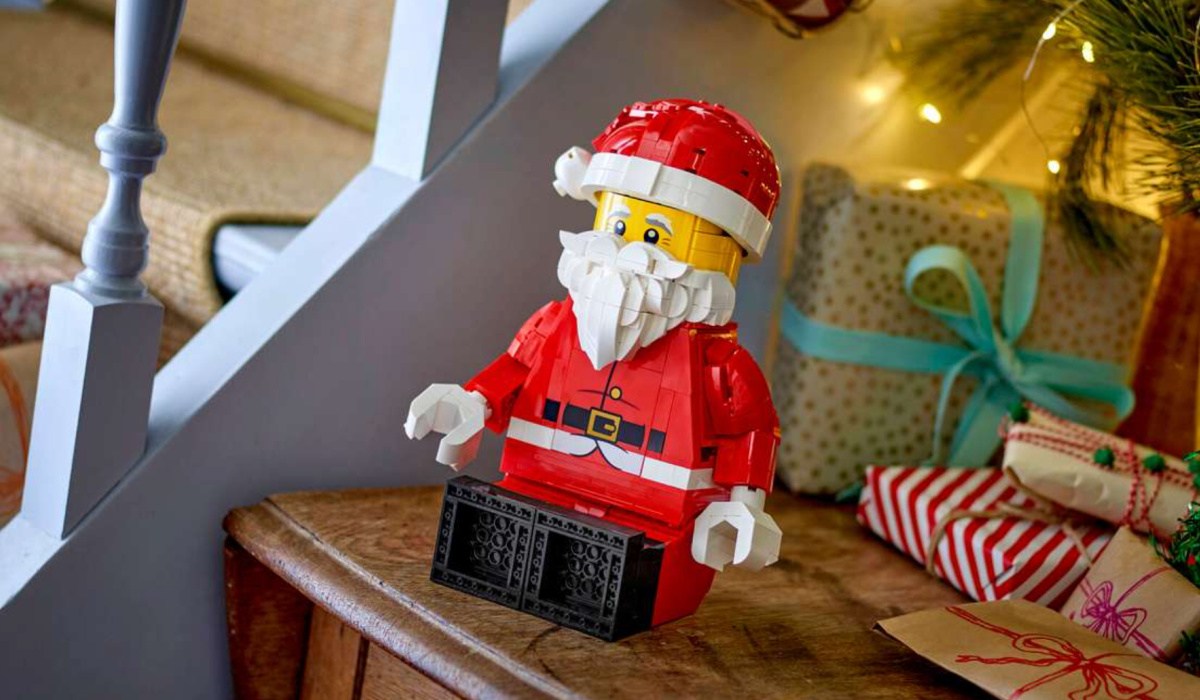 LEGO Santa Figure sitting in front of christmas tree