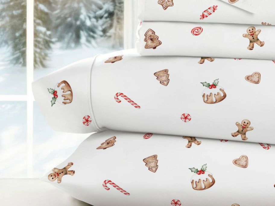 A stack of Linen's & Hutch Sheets with Gingerbread Print