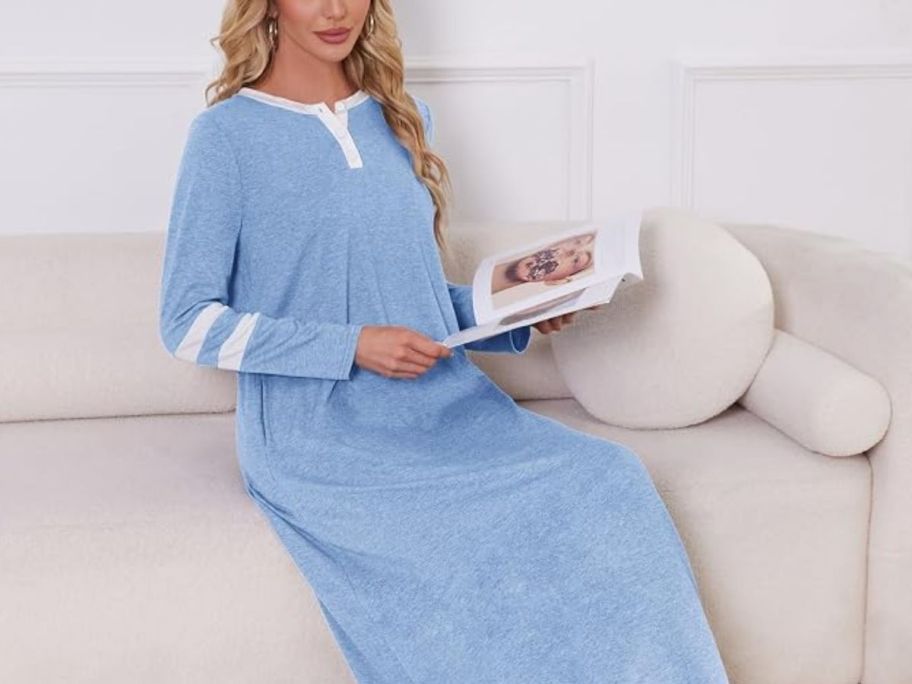 woman sitting on the couch wearing a Blue and white Long sleeve gown while reading a book
