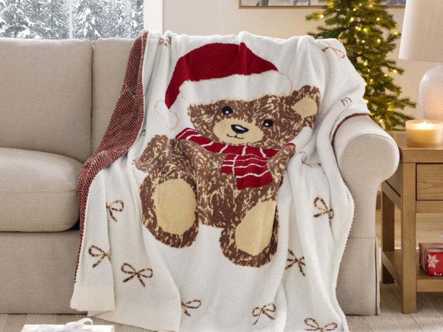 a teddy bear throw draped over a sofa