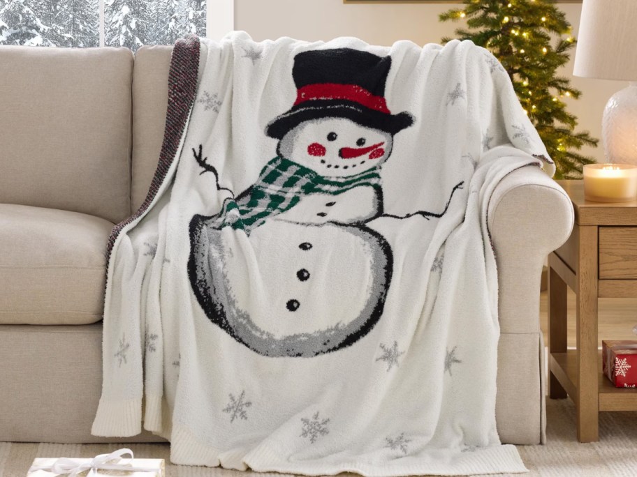 a snowman throw draped over a sofa