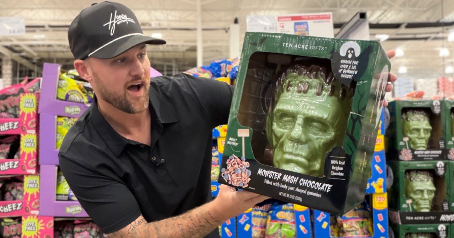 Man holding a giant Monster Mash Chocolate Frankenstein head from Ten Acre Gifts in a Costco store.