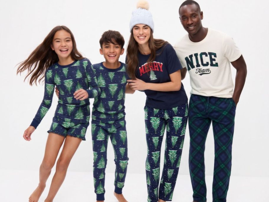 Girl, boy, woman and man wearing Old Navy Holiday Pajamas