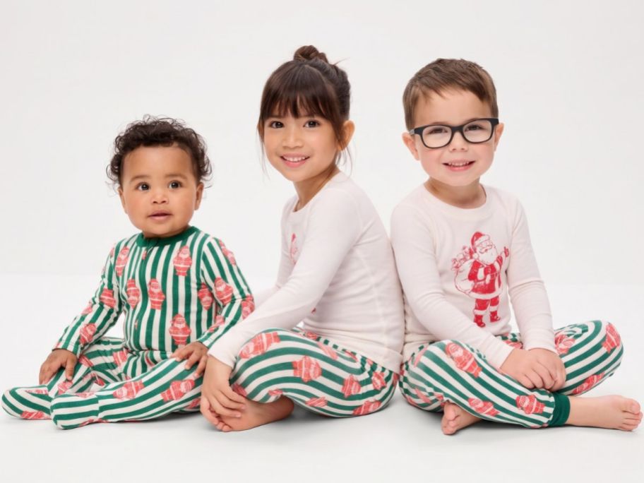 Baby, toddler girl and toddler boy wearing matching Old Navy holiday pajamas