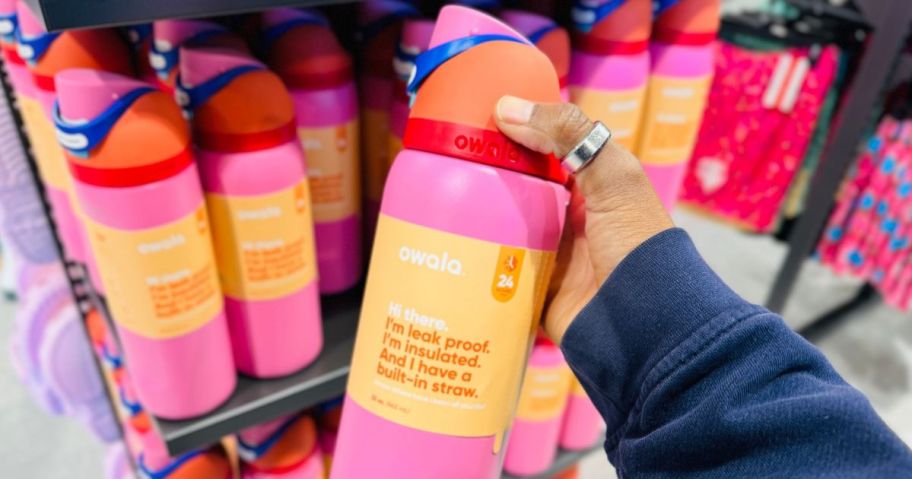 Hand holding a pink Owala Freesip Tumbler at Dick's Sporting Goods