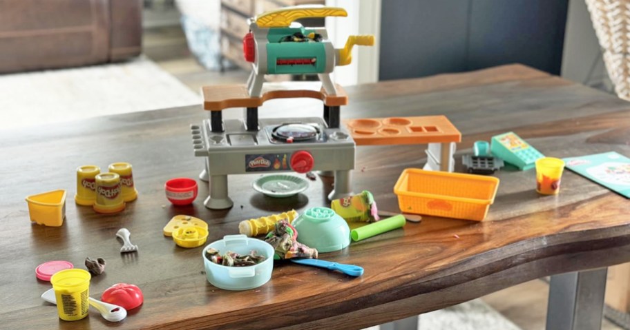 Play-Doh kitchen playset on a wood table with accessories
