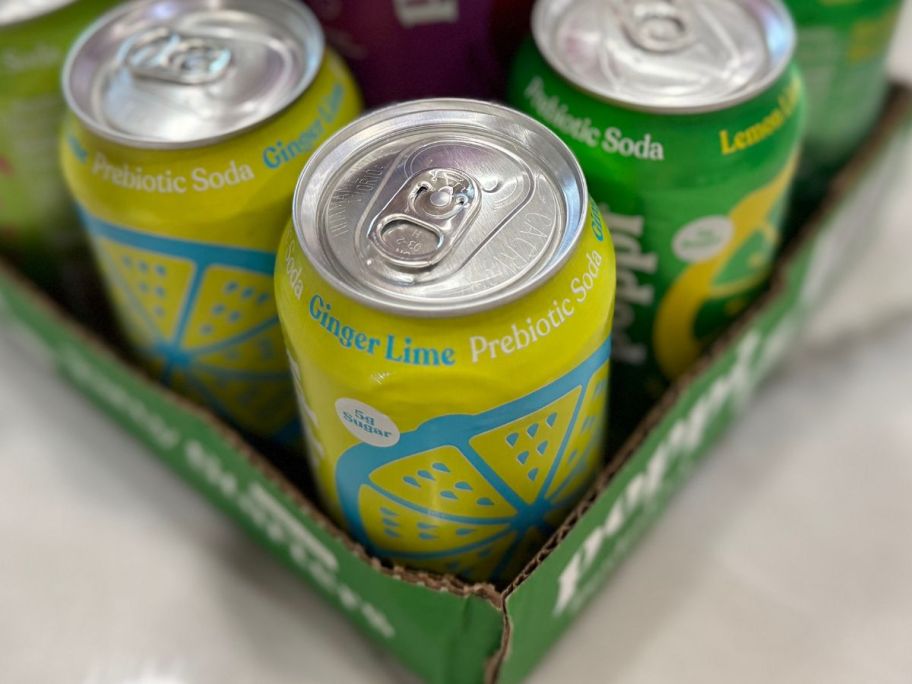 Poppi Soda cans in box on counter