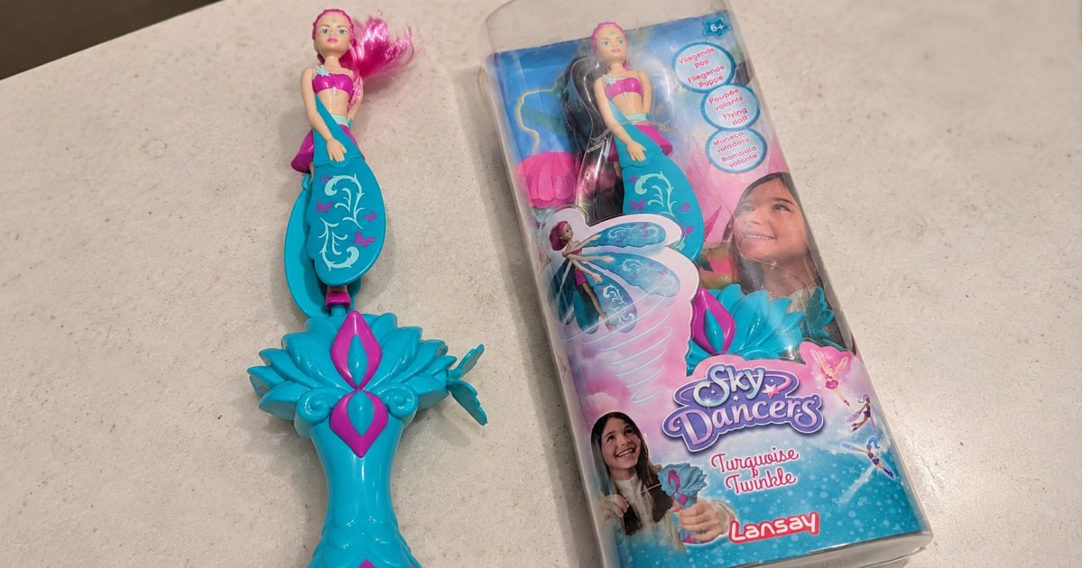Sky dancers flying doll toy in turquoise on countertop