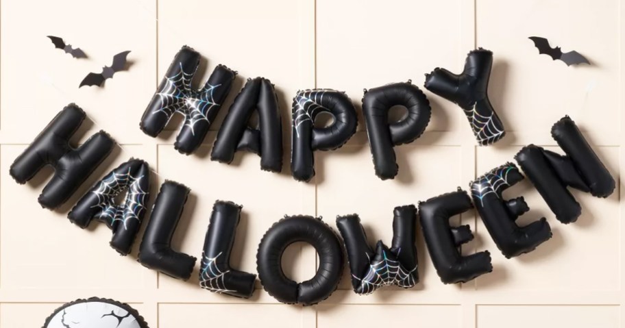black balloon banner that says happy halloween