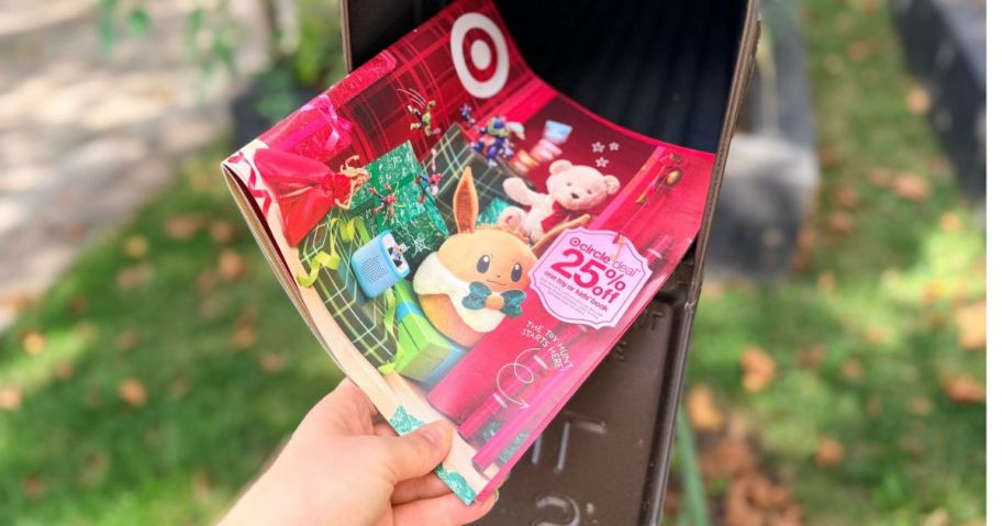 A hand pulling a Target Toy Catalog out of a Mailbox
