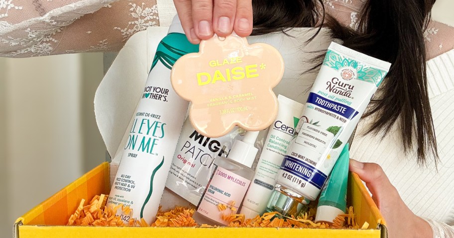 woman holding up a flower body spray from walmart beauty box