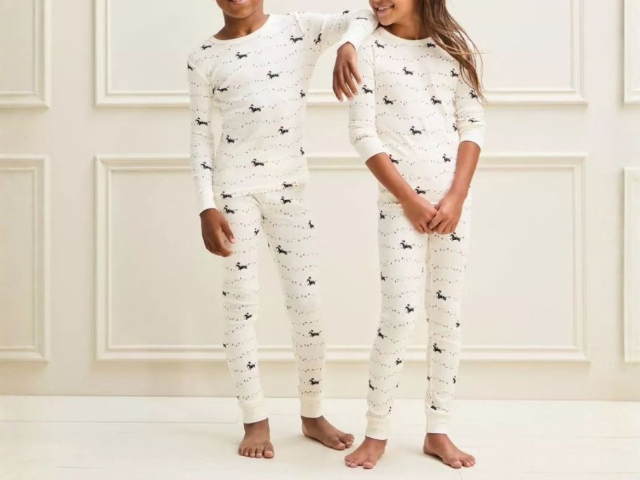 two kids wearing Wondershop Holiday Dachshund Matching Pajamas
