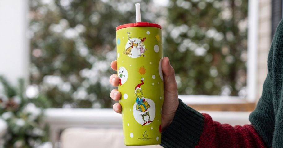 Handing holding a Zak 30oz Grinch Holiday Tumbler