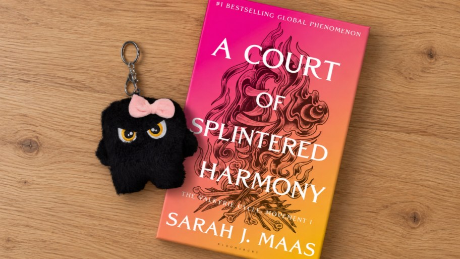 a book and a key chain on a desktop