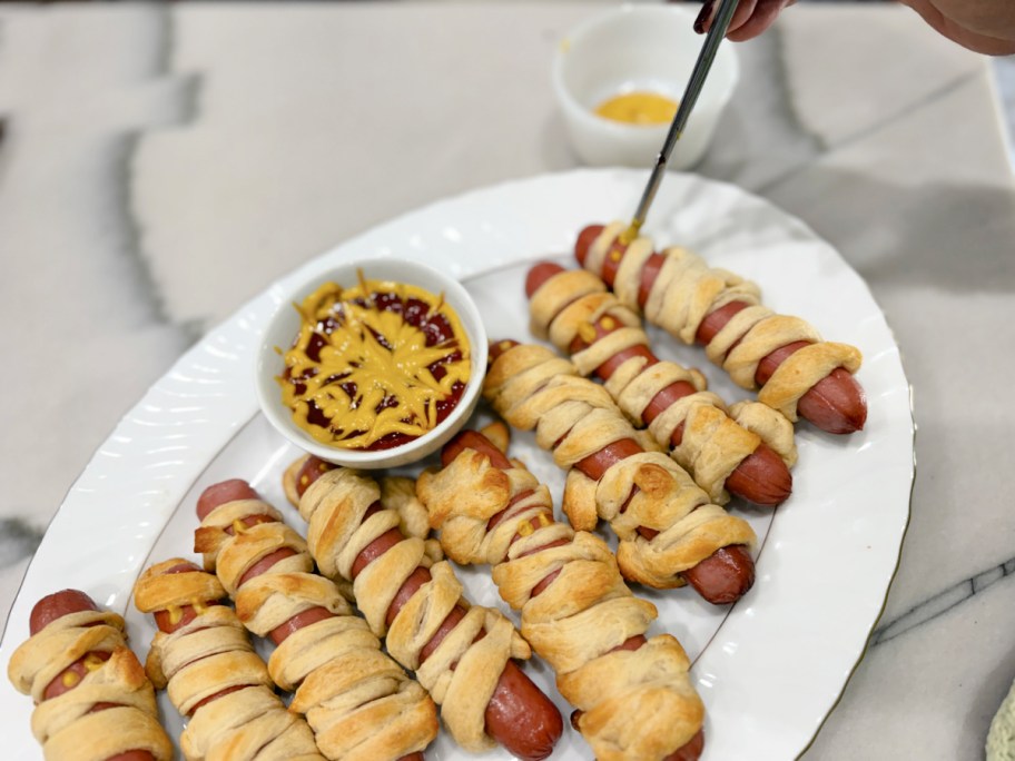 adding mustard eyes to mummy dogs