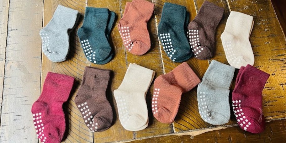 colorful baby socks laying on table