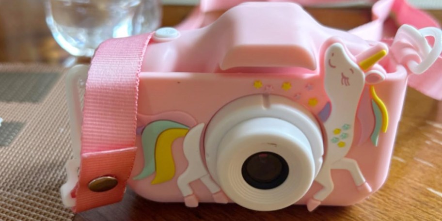 pink unicorn camera on desk