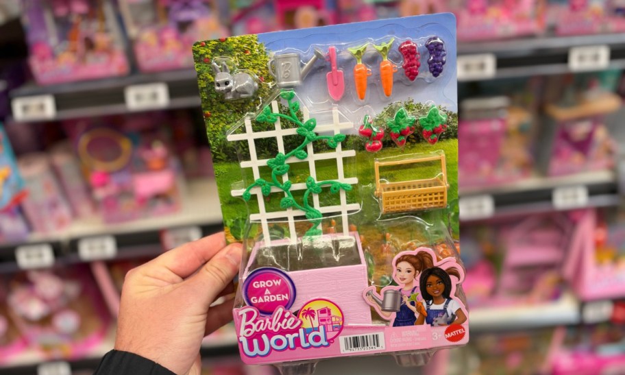 hand holding fashion doll garden set