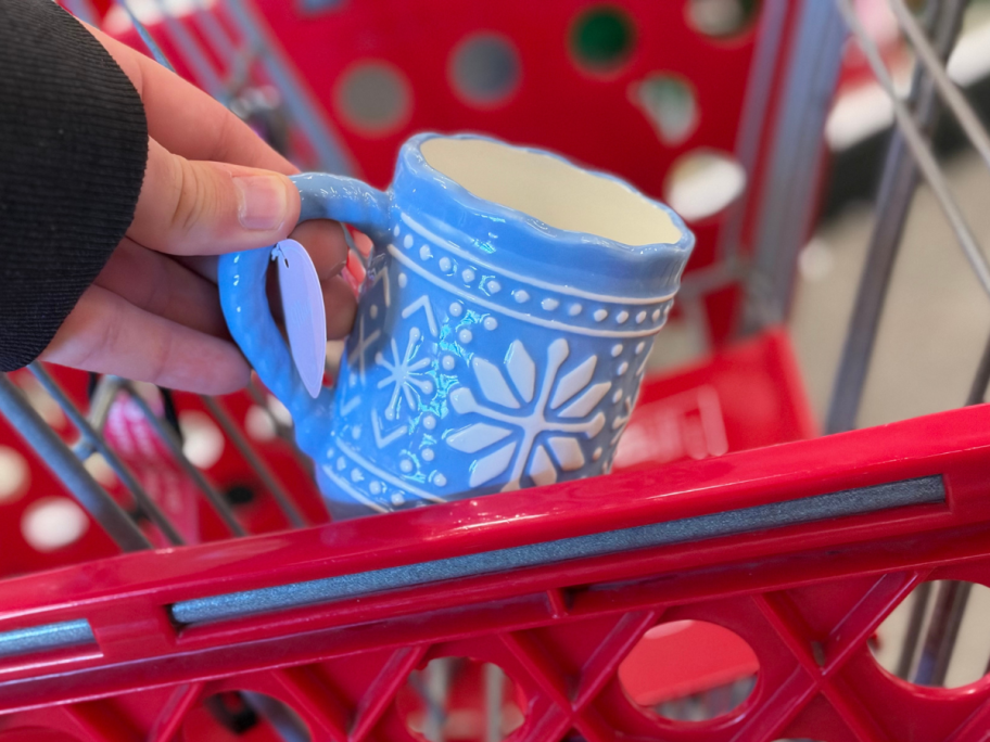 hand holding blue snowflake mug in target card