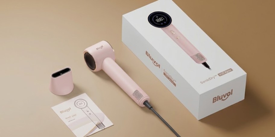 pink hair dryer with box on table