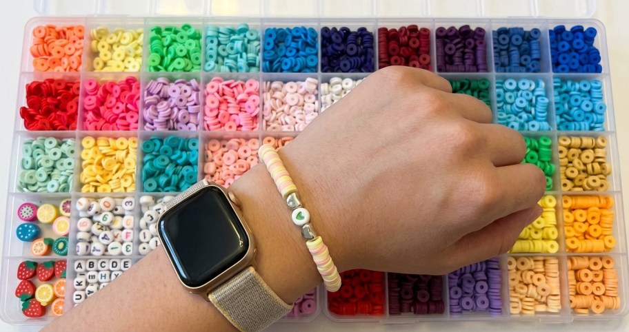 hand with bracelet on it, next to a bracelet kit