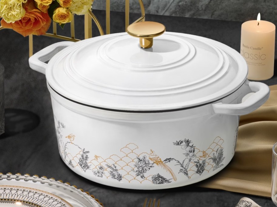 a white floral and gold dutch oven