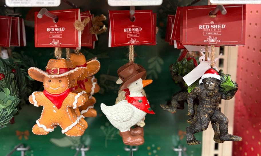 three chirstmas ornamnets on display on a store aisle