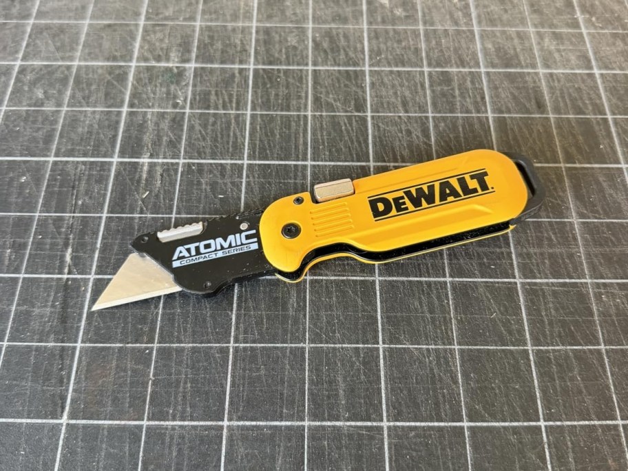 yellow utility knife on a gray grid