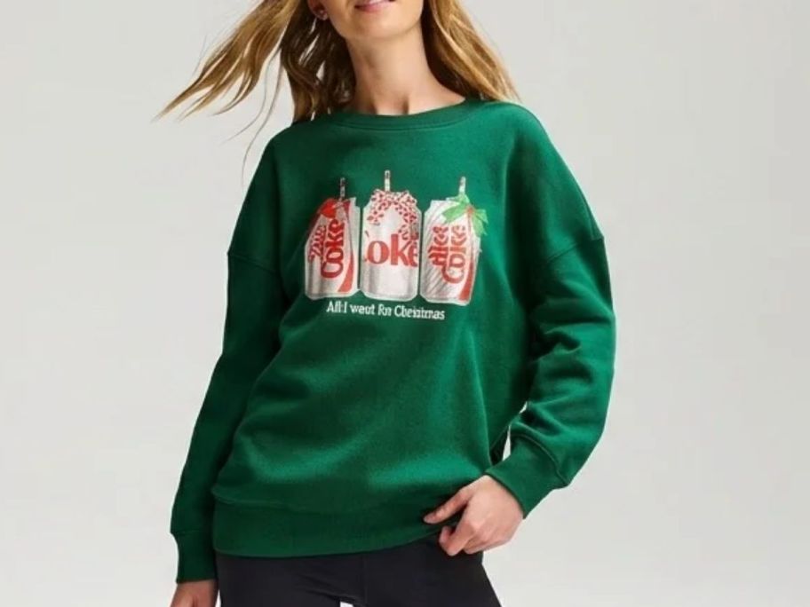 woman wearing a diet coke green christmas sweatshirt