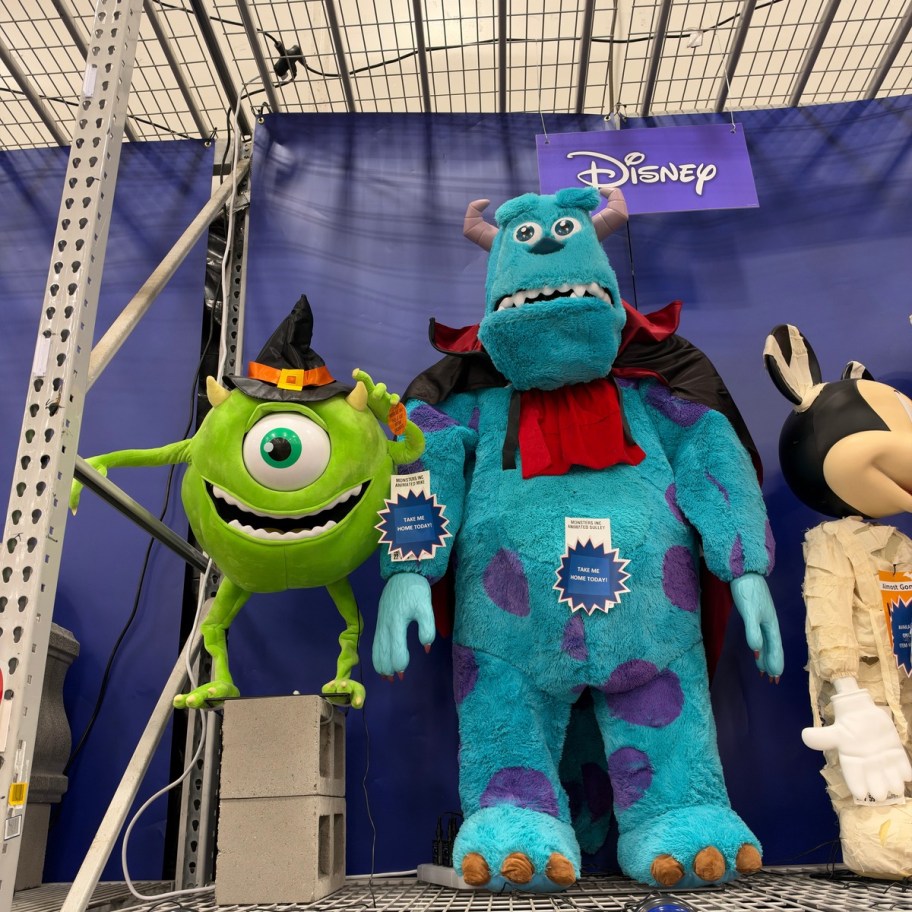 two monster animatronics on a store shelf