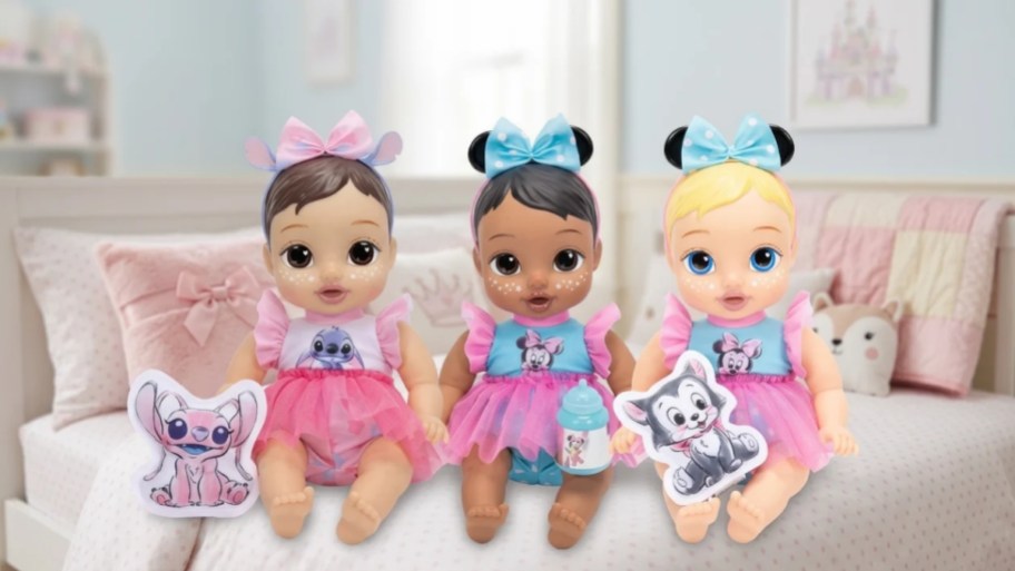 three baby dolls on a little girls bed