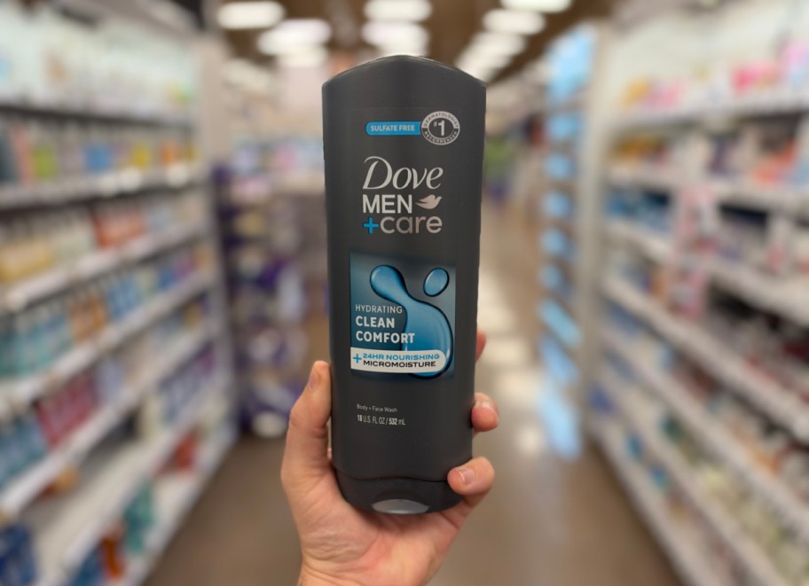 hand holding up a bottle of body wash in a store