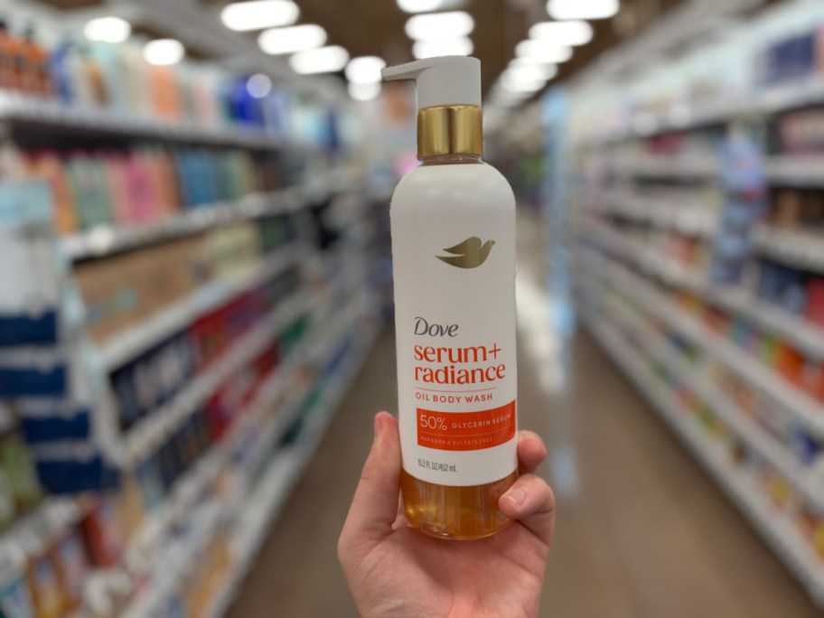 hand holding a body of dove body wash in a store aisle