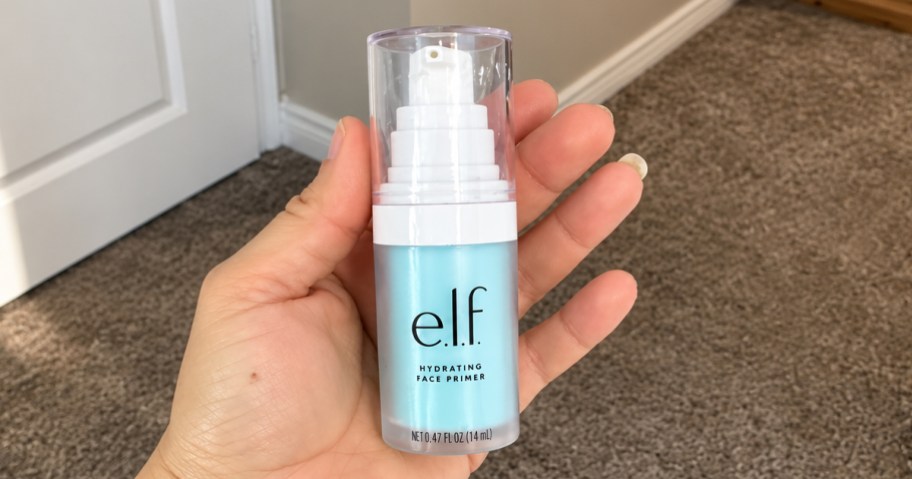 hand holding up small blue bottle of e.l.f. Hydrating Face Primer