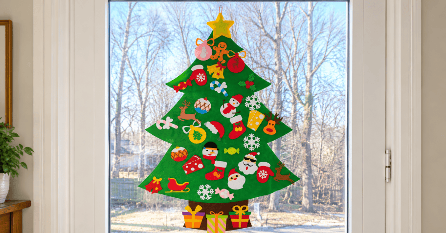 green felt christmas tree hanging in a window