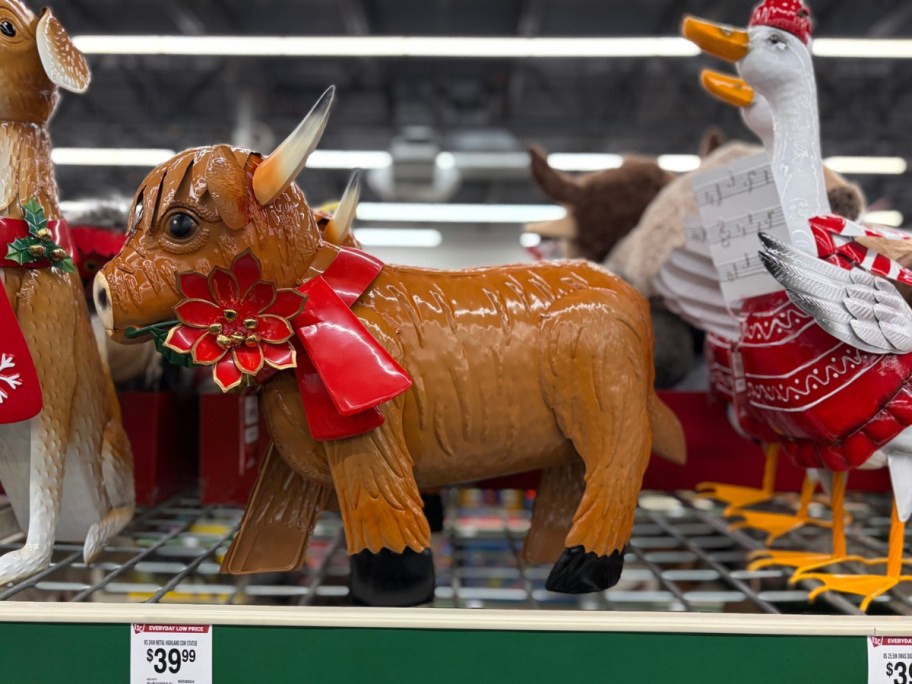 a brown highland cow metal statue