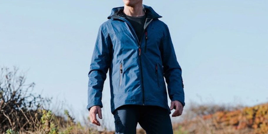 man wearing blue jacket outdoors