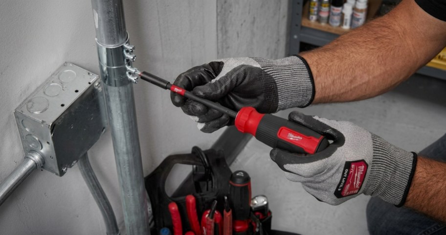 man using hand tools to fix something