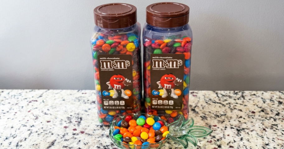 2 jars of milk chocolate m&m's on a countertop
