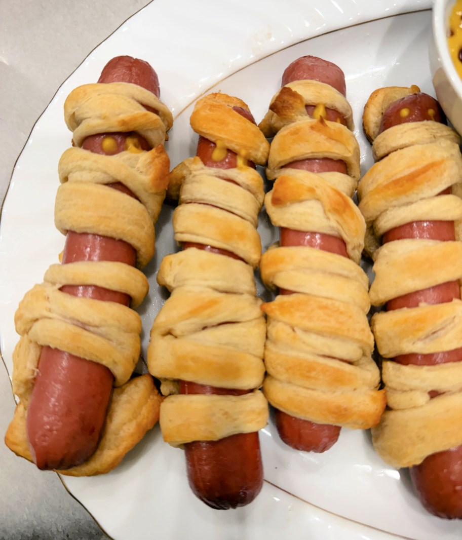 mummy hot dogs on a platter for halloween
