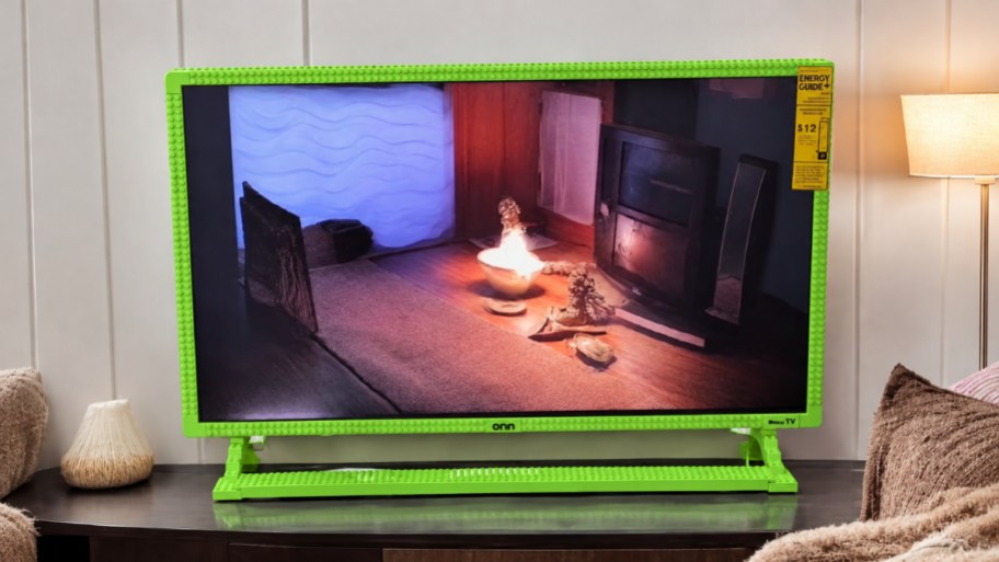 a green building block framed tv on a tv stand