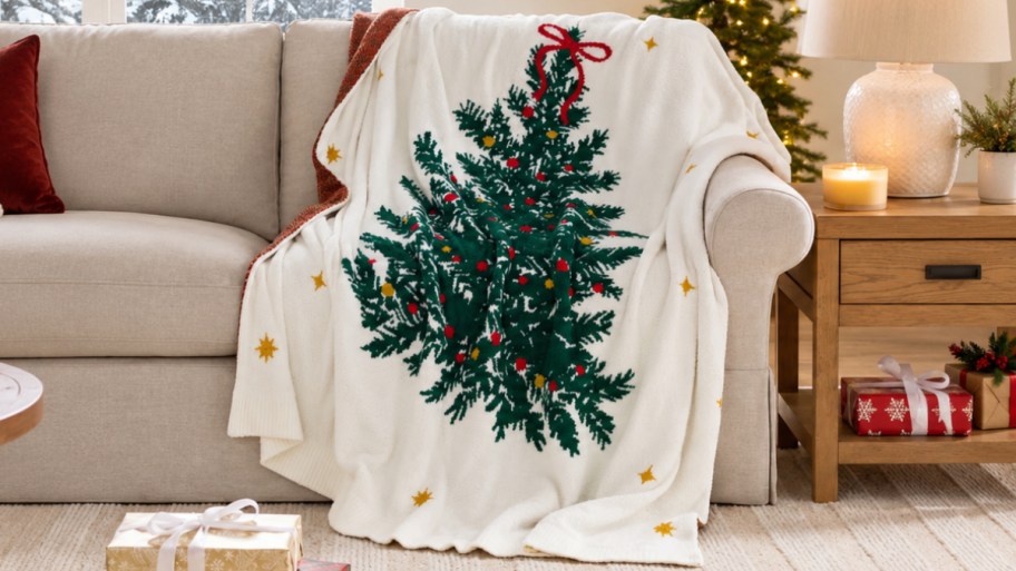 a christmas tree throw draped over a sofa