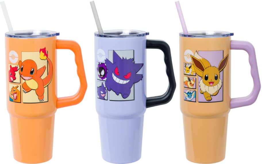 Three Silver Buffalo Pok&eacute;mon tumblers with handles and straws displayed side by side, featuring Charmander in orange, Gengar in purple, and Eevee in tan.