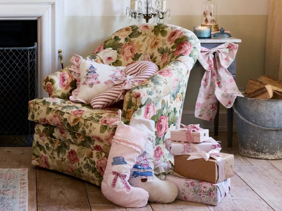 pastel Christmas stockings and pillows displayed on floral chair