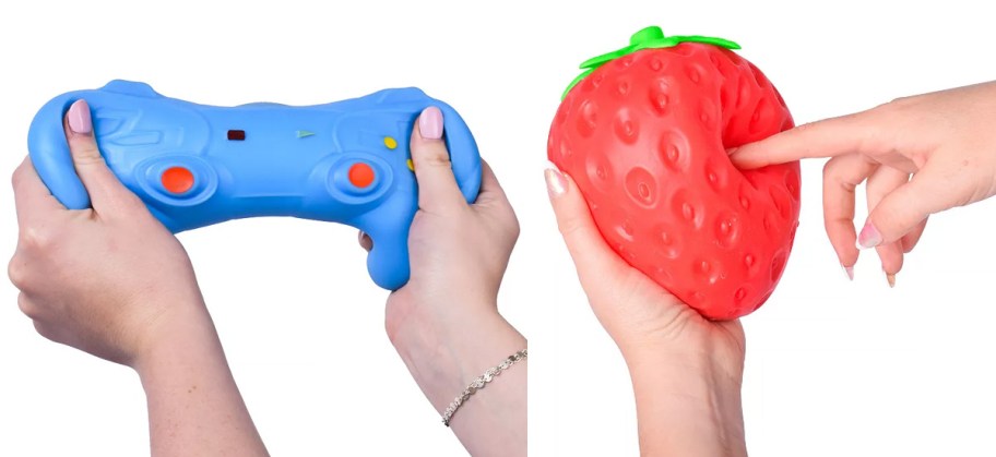 hands holding blue controller and red strawberry squishy toys 