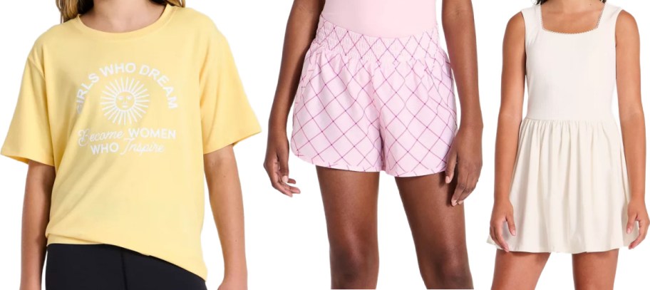 Three styles of children's clothing displayed side by side, featuring a yellow graphic t-shirt on the left, pink patterned athletic shorts in the middle, and a white sleeveless dress on the right.