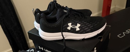 a black and white pair of under armour mens running shoes