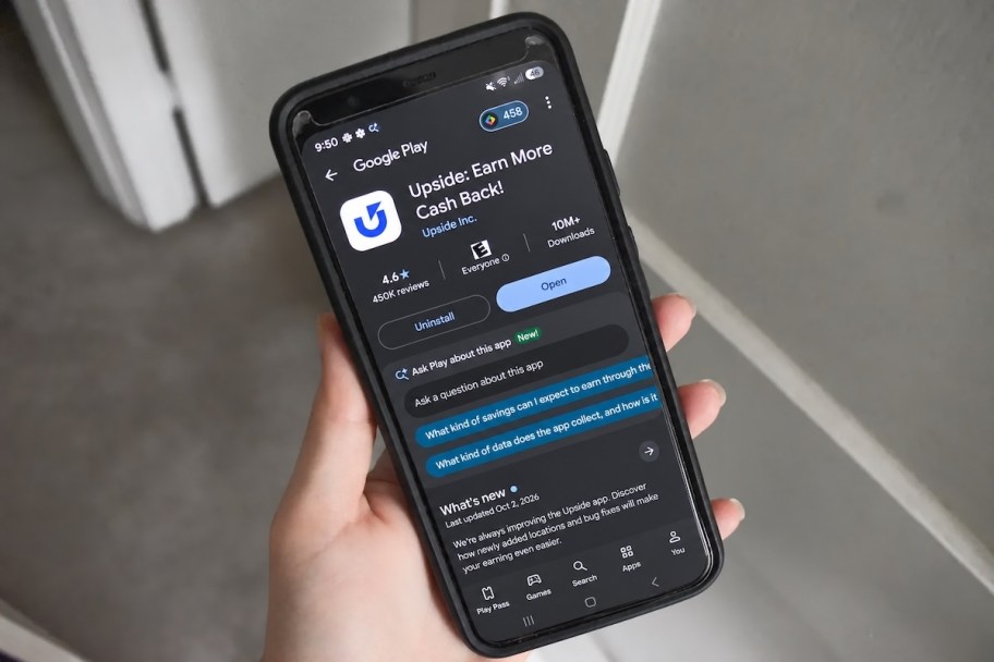 hand holding phone with upside app on screen