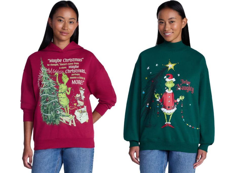 2 women wearing Grinch sweatshirts on a white background